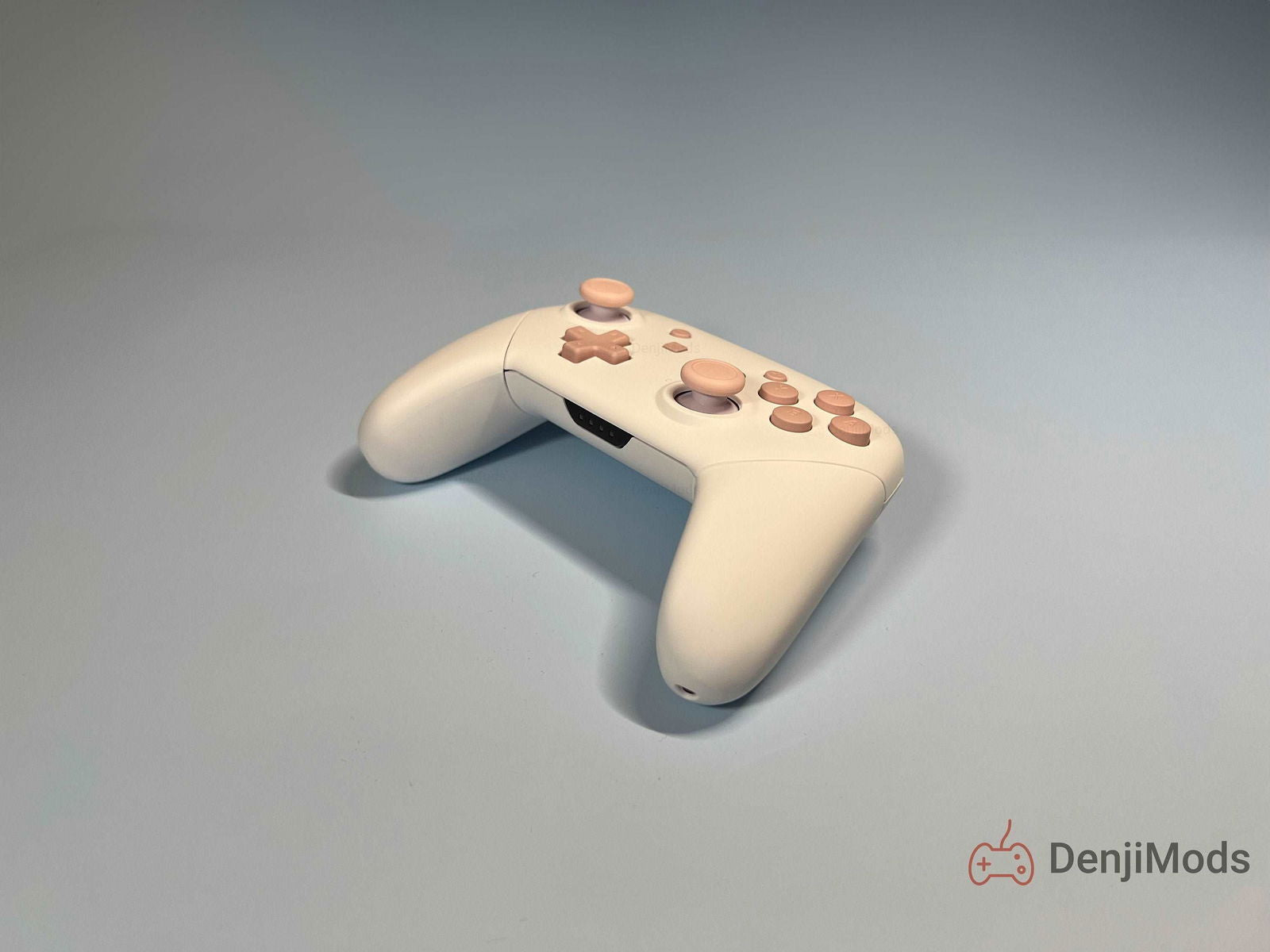 Custom Matte White Nintendo Switch Pro Controller with pastel buttons on light background.